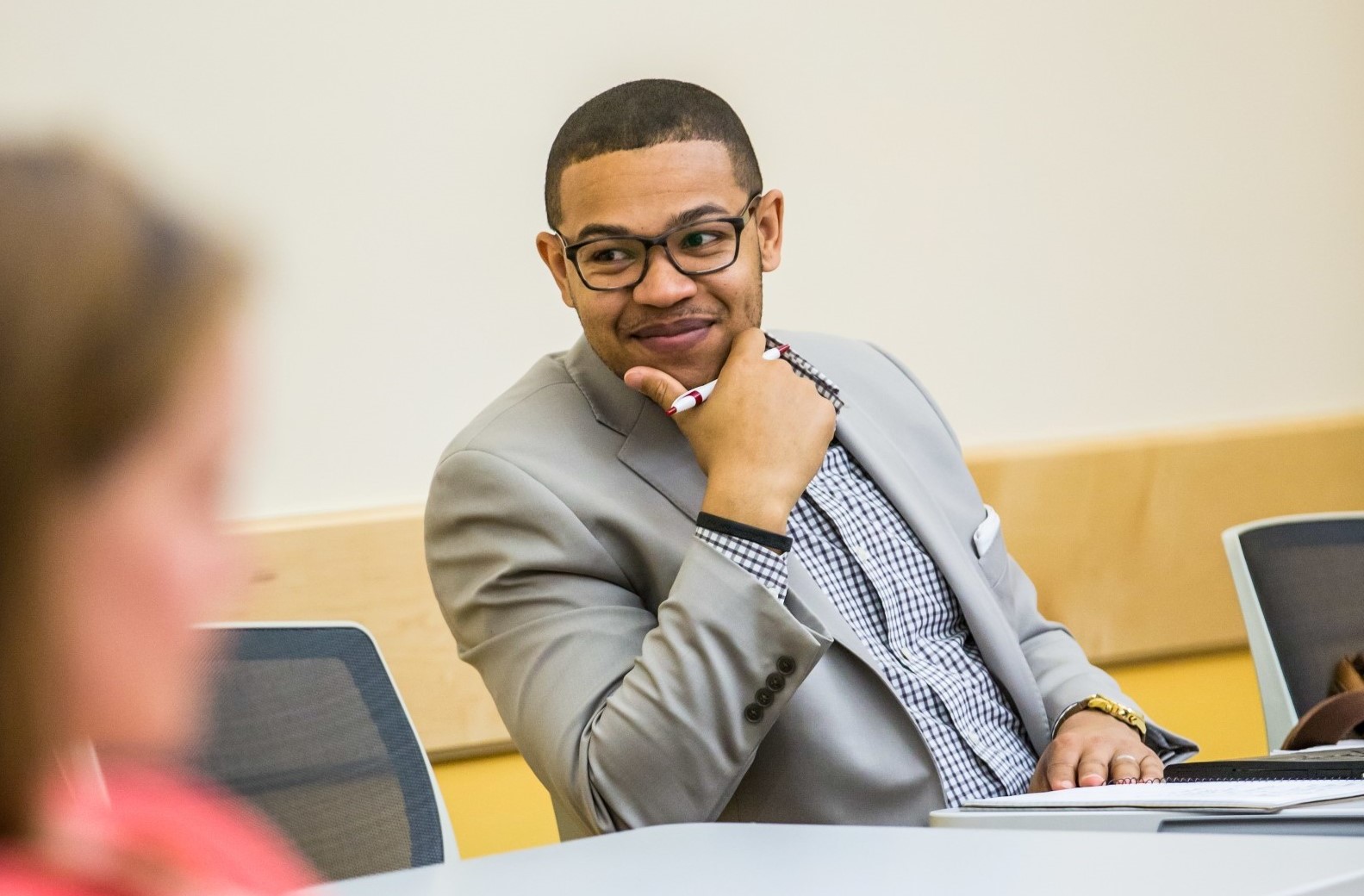 male student smiling in class