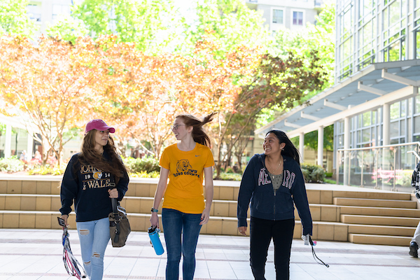 three students walking together through the JWU Charlotte campus