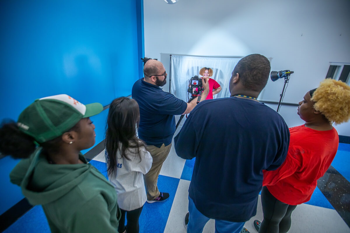Students in media class learning about photography and lighting