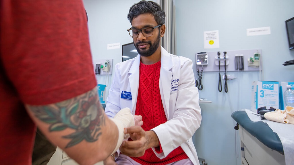 student learning how to put cast on a patient