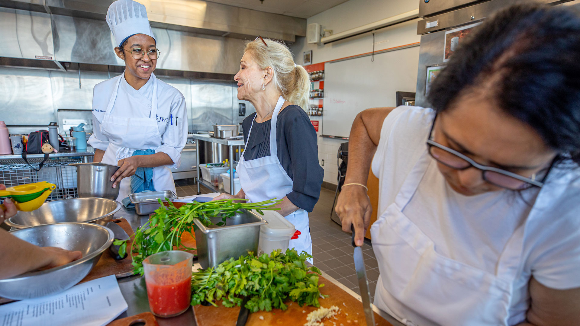 Teaching Kitchen students learning knife skills during a cooking and nutrition segment.
