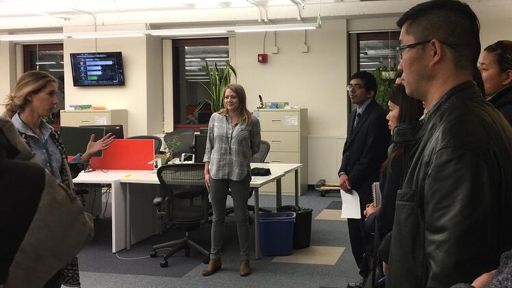 Upserve staff Courtney Nardozza, senior talent business partner and JWU alumna Nicole Theohary'15, manager, customer service give JWU MBA students a tour of Upserve.