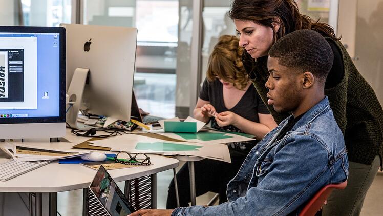 Associate Professor Deana Marzocchi working with students on a design project