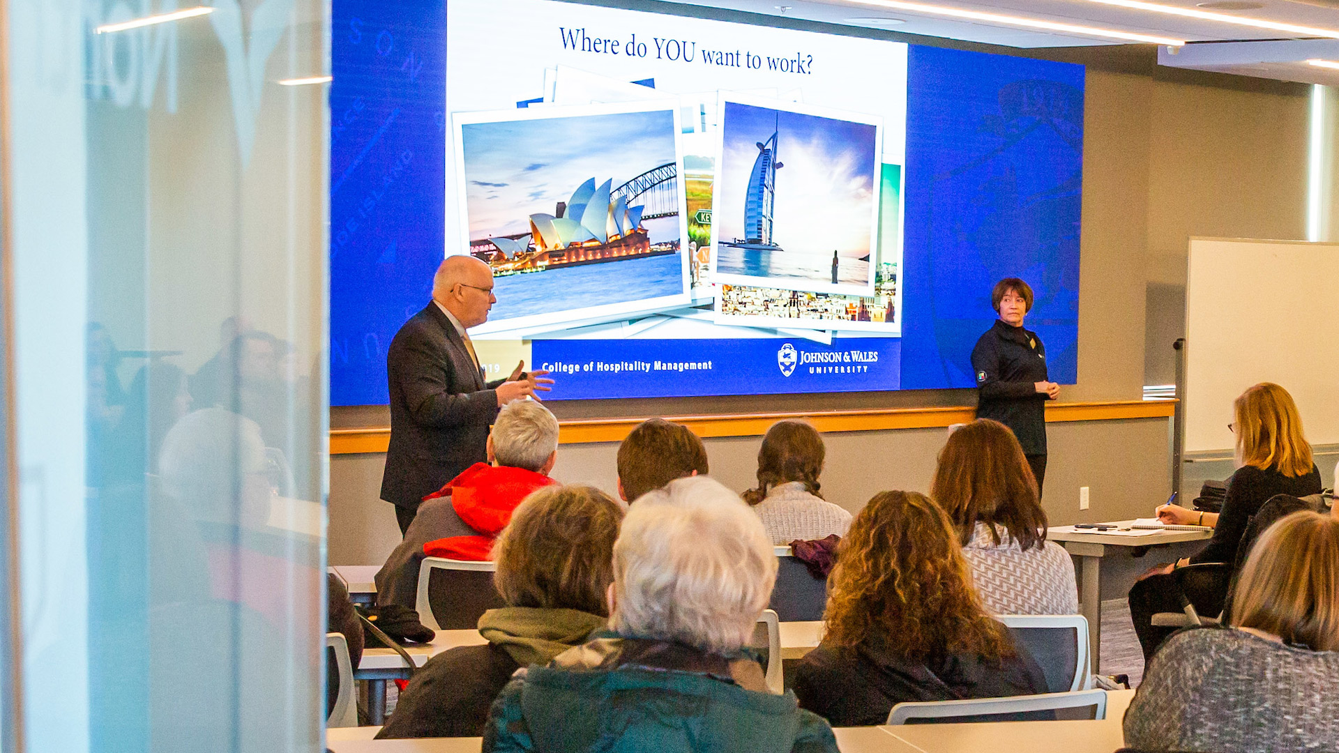 Dean Paul McVety ’09, Ed.D. and Associate Professor Brenda Eckler welcome students to JWU Hospitality Experience Day.