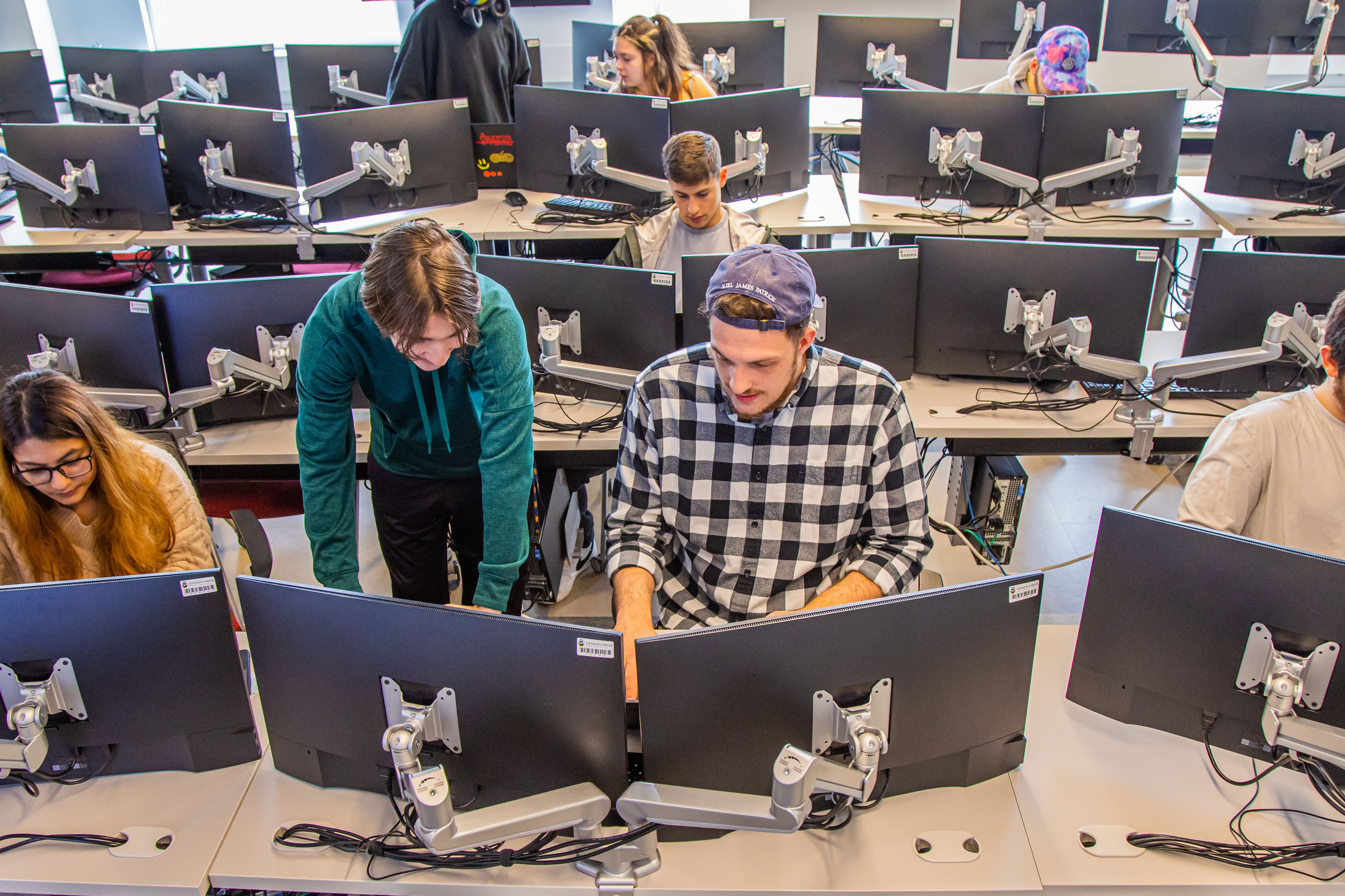 students collaborating on projects in computer lab