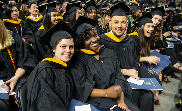 Students in caps and gowns at commencement